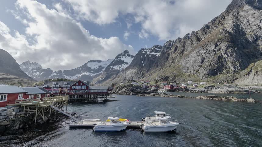 Time lapse of a dock as boats pass and float around near the pier