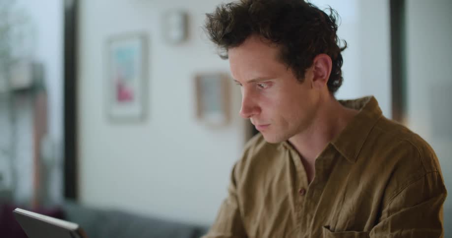 A man using a tablet in a house