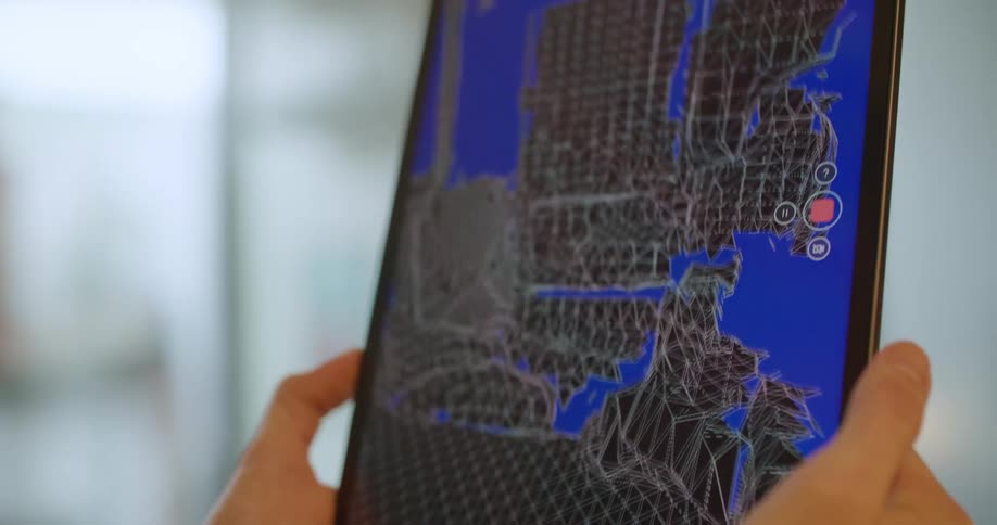 A man is 3d scanning a room