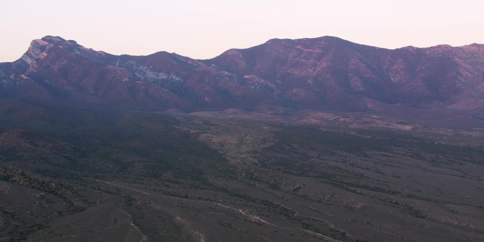Rough terrain in a field matches the rough terrain of a nearby canyon