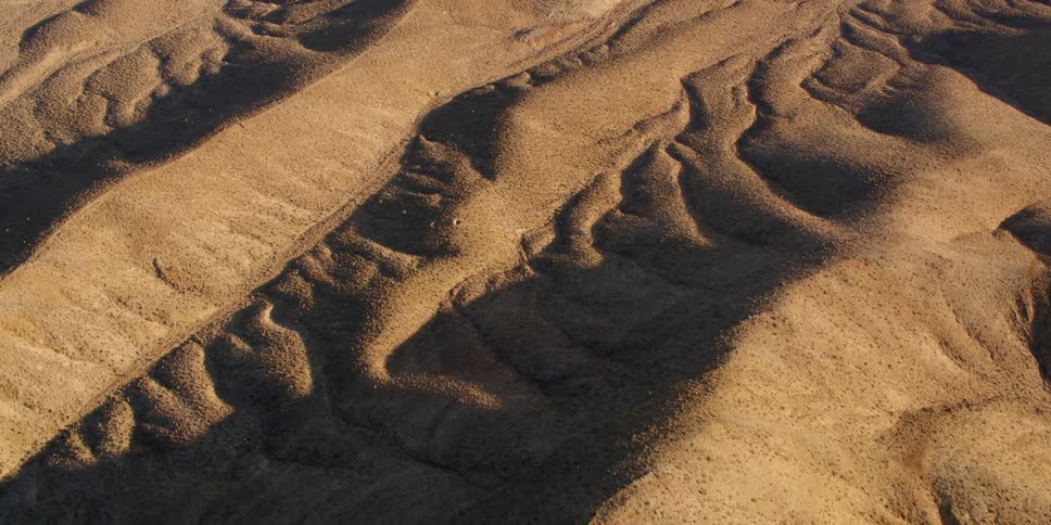 The bare topography of a mountain area is sandy and barren