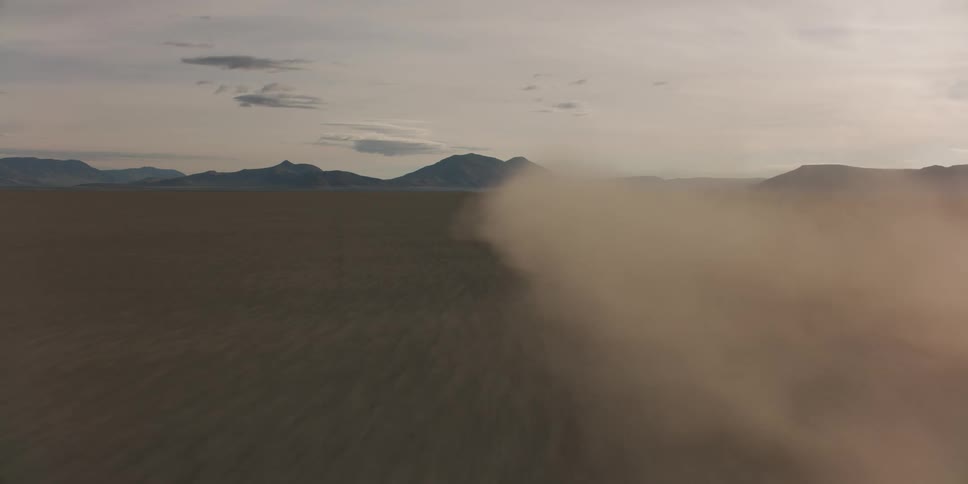 Dust clouds fill the large desert
