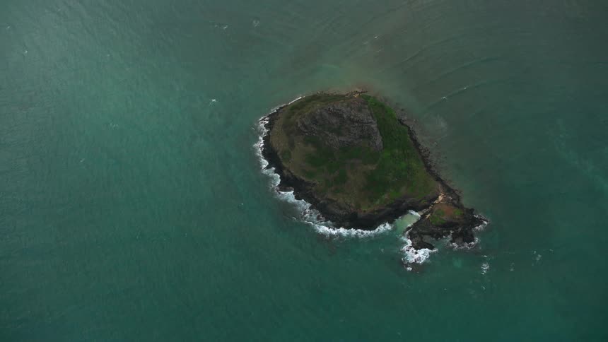 An island surrounded by water and waves