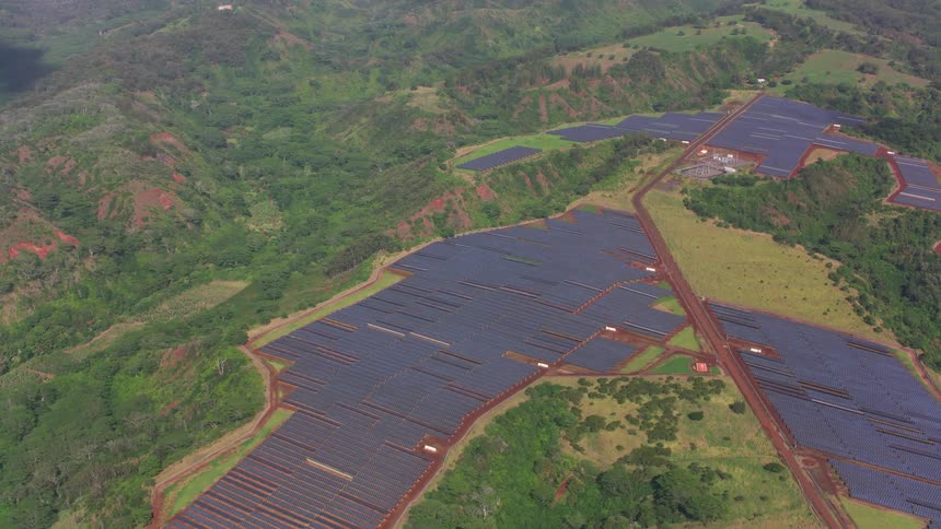 The fields below are covered with solar panels