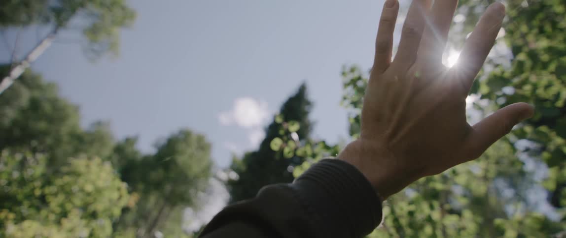 Person covering sun with hand