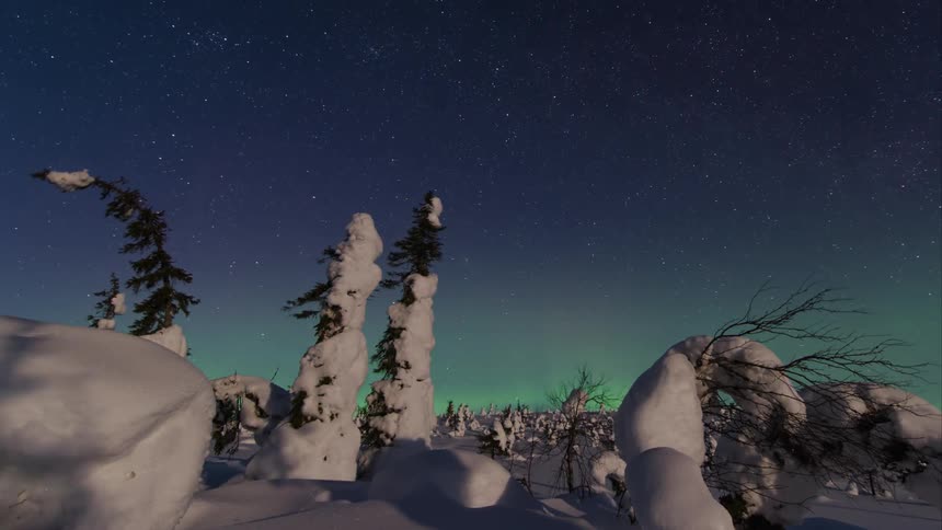 Time lapse of northern lights and a starry sky over an eerie winter landscape with shifting shadows
