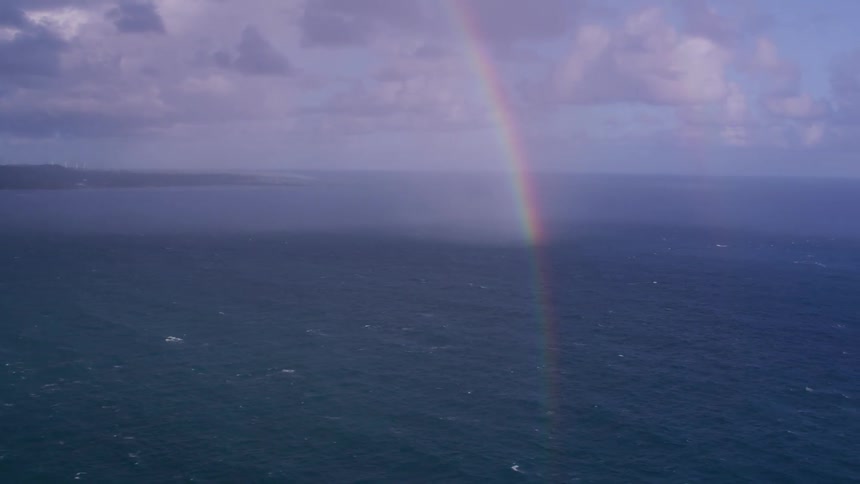 A rainbow over the ocean near shore