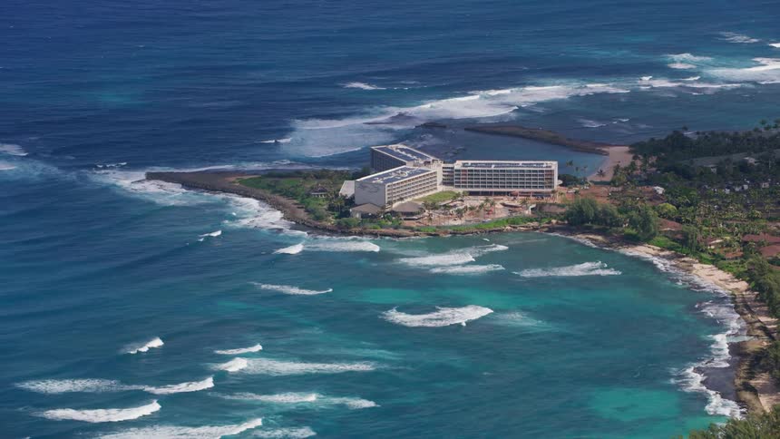 A building complex on a peninsula on the sea during the day