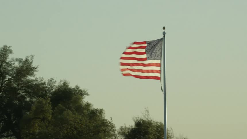 A panning shot of a flagpole