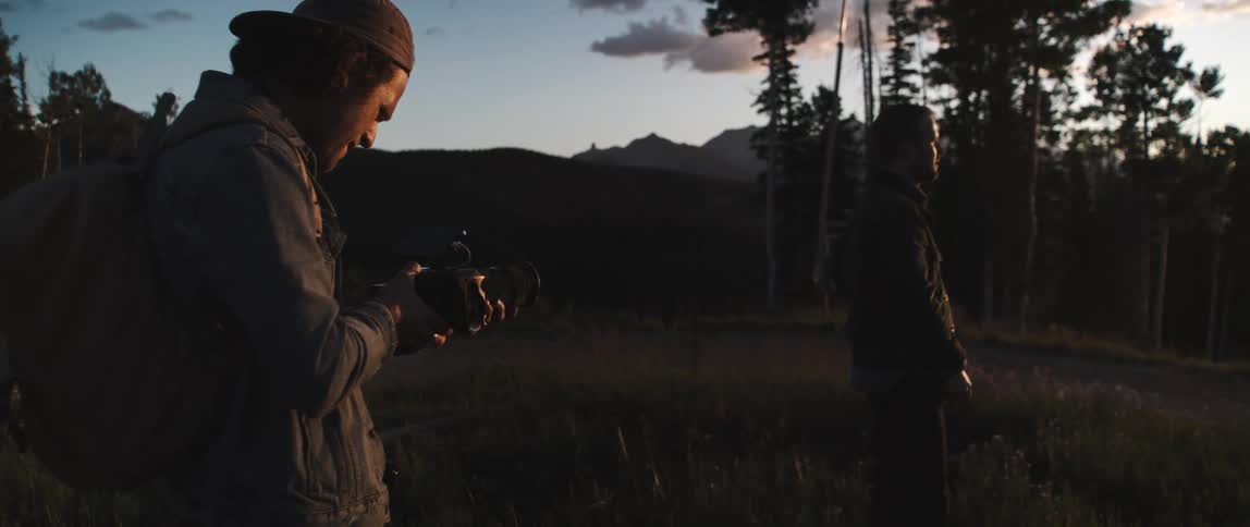 A man taking photos of another man