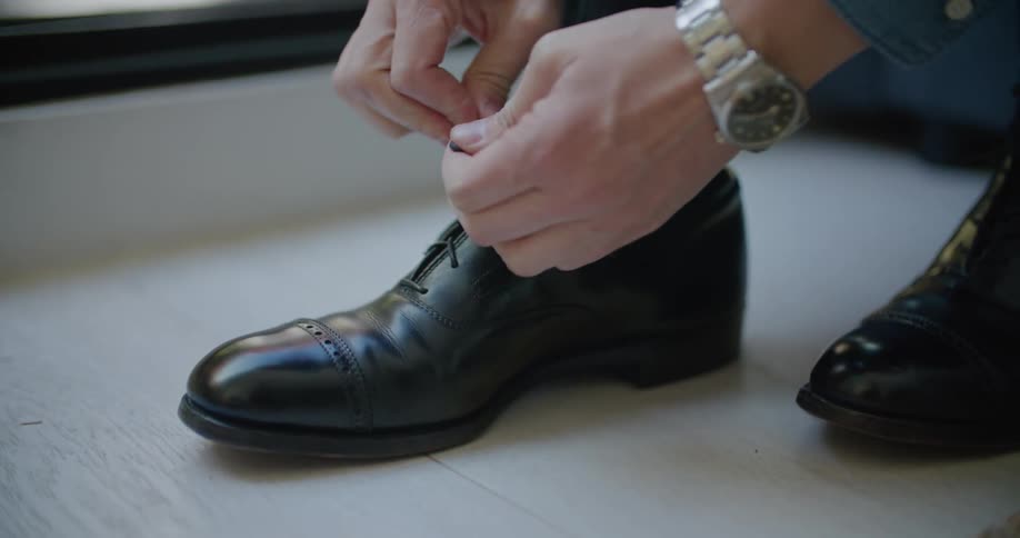 A man tying his shoes