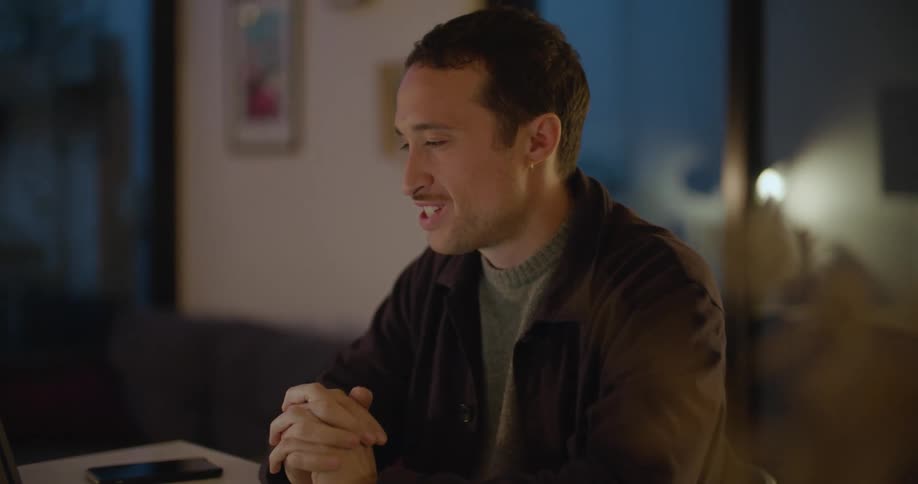 A man is talking into his tablet