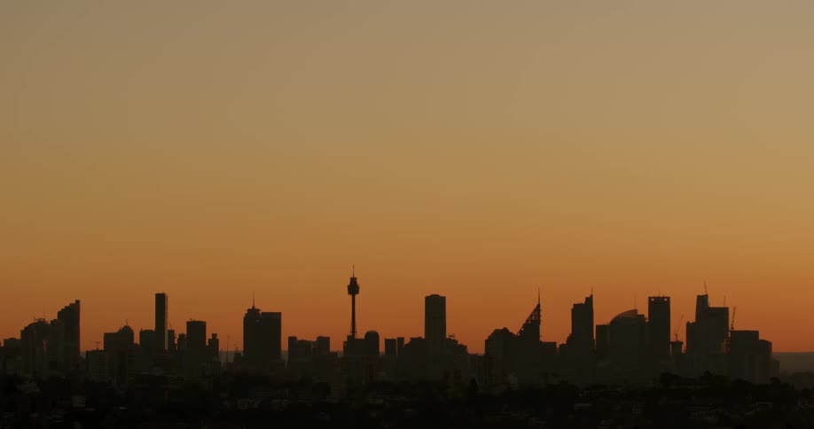 A city skyline with buildings and skyscrapers with the sky and clouds in the background