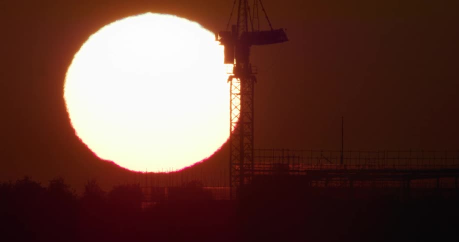 The sun rises over an oil rig