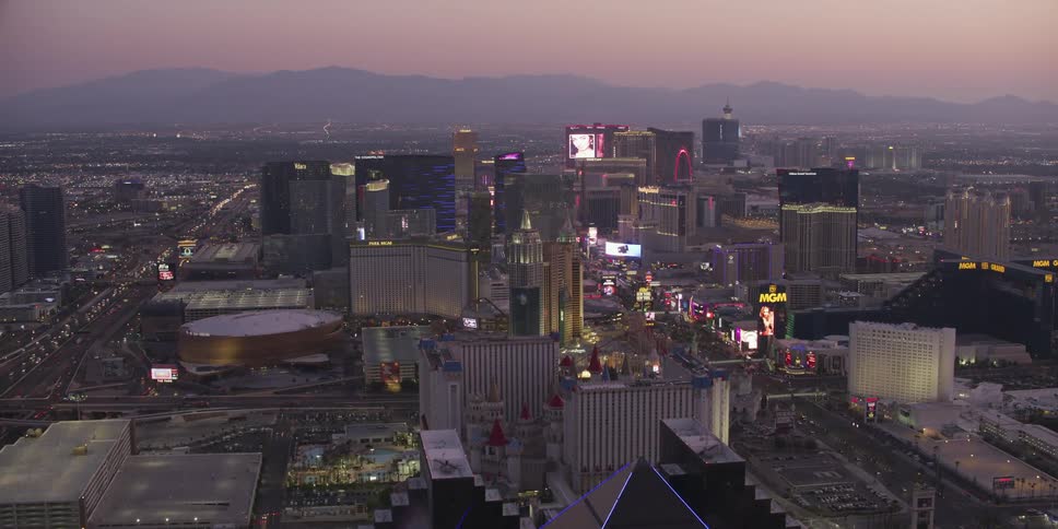 An aerial view of buildings in a city at sunset