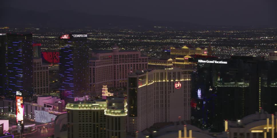 Neon lights on buildings compete for attention in a busy downtown