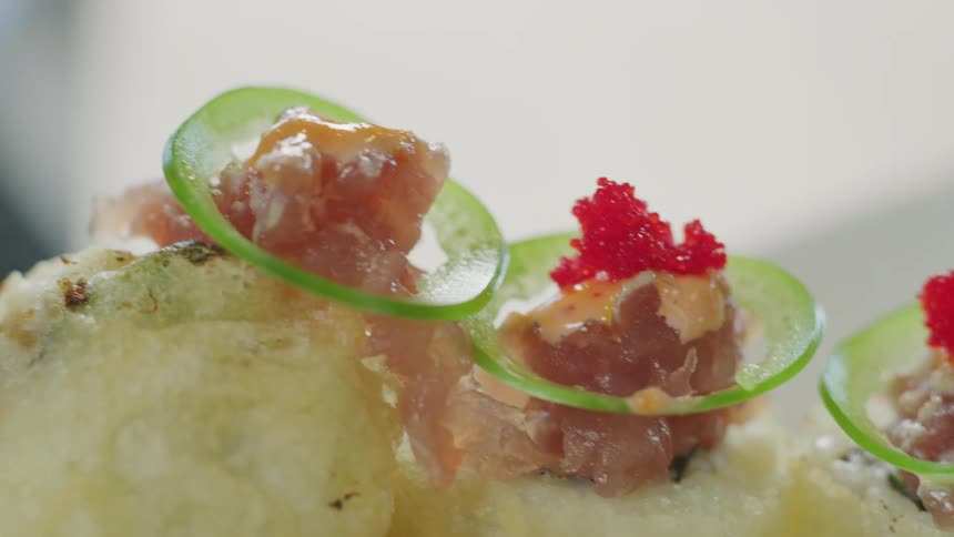 A chef adding garnish to a dish