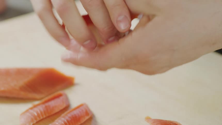 A person assembling sushi