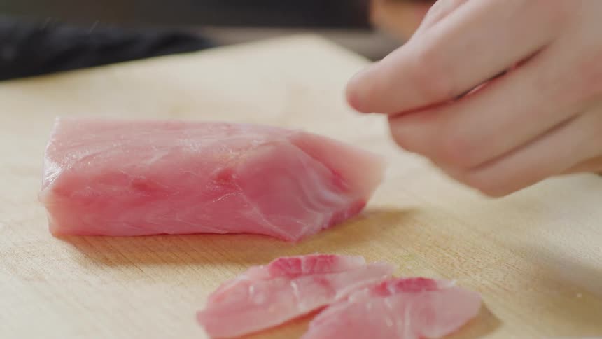 Person cutting fish