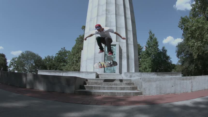 A man skateboards over some steps