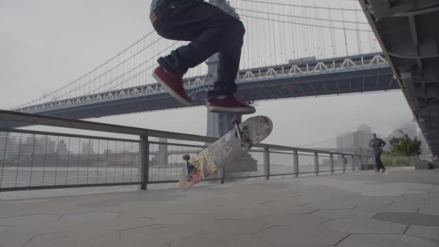 A man does a jump on his skateboard