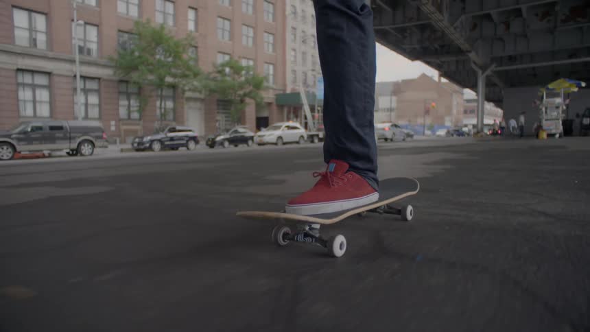 A person in red shoes is skateboarding