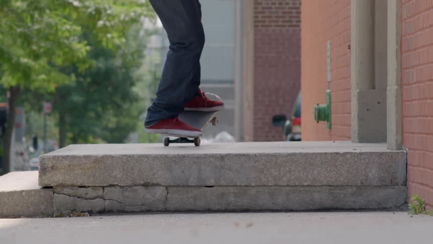 A man rides a skateboard and does a jump