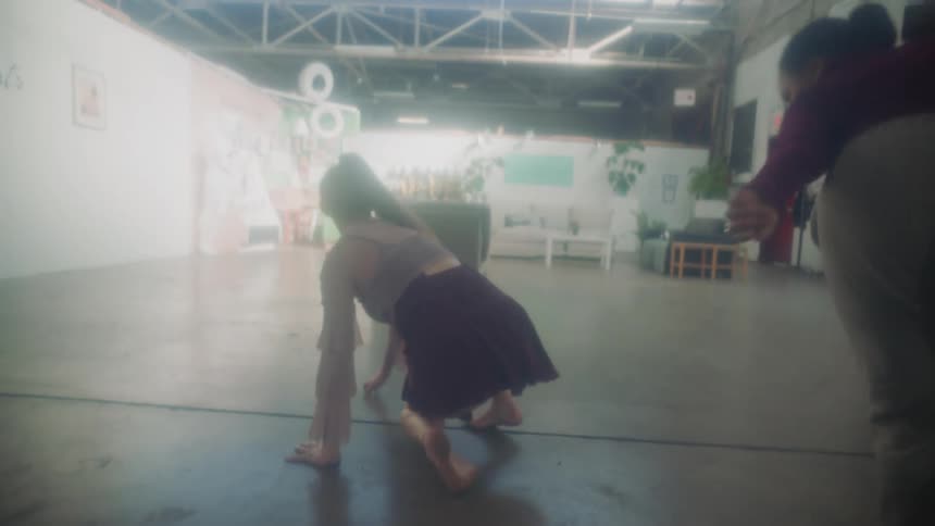Two people that are dancing in a studio