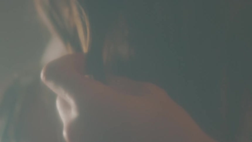 A female runs her fingers through her hair
