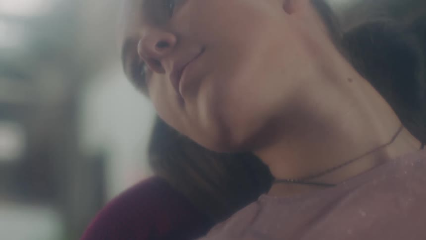 A close up of a woman laying weirdly on a chair