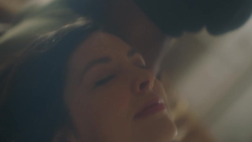 Young man and woman dancing inside a room