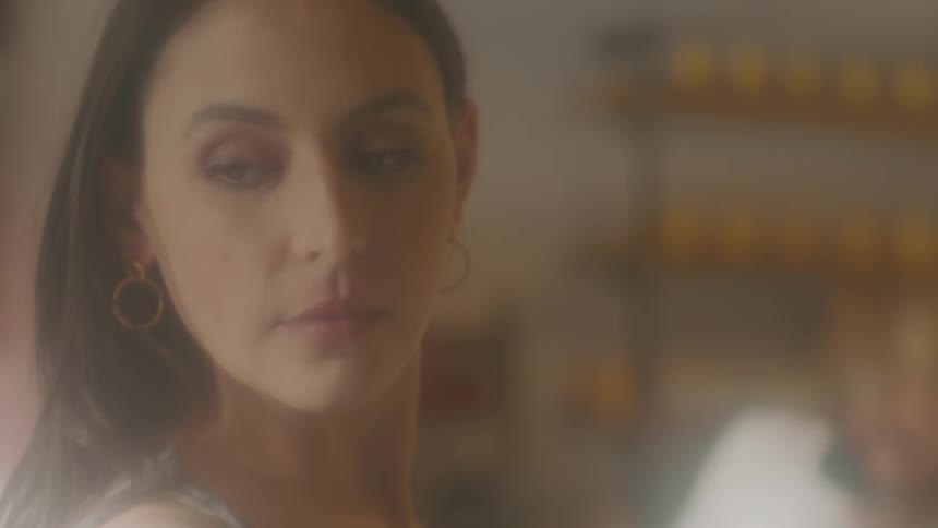 Woman wearing ring earring looks over her shoulder