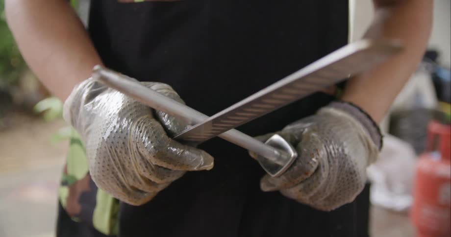 Person sharpening knives