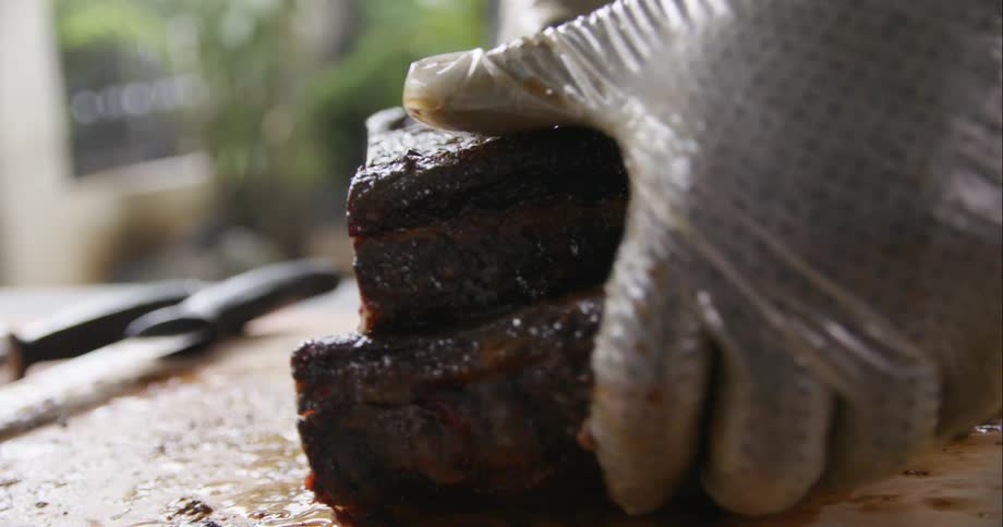 A man placing meat on a cutting board