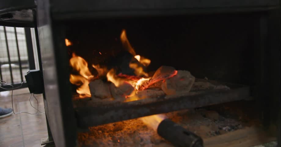 A flame lighting a fire in a stove