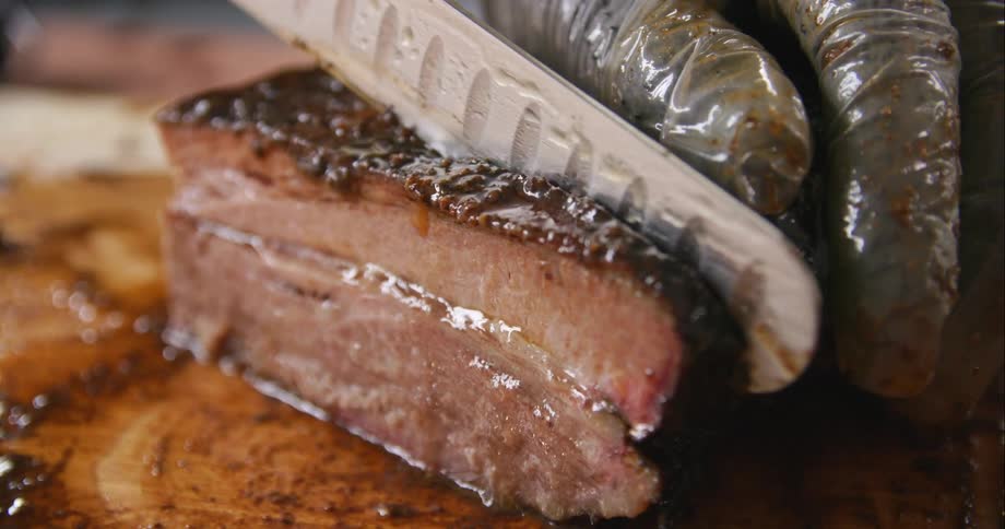 A close up of a steak being cut