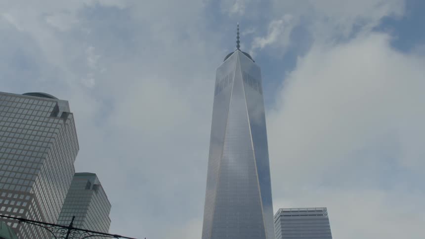 A tall mirrored building in a city