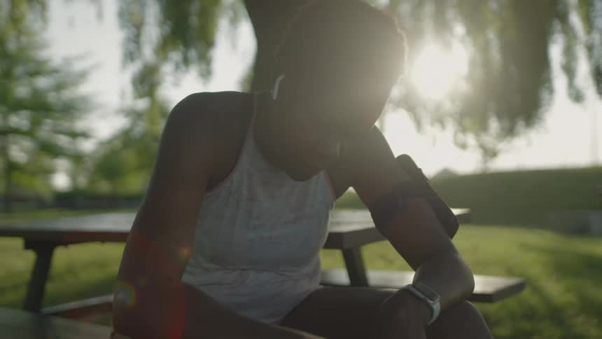 A woman sitting on a park table