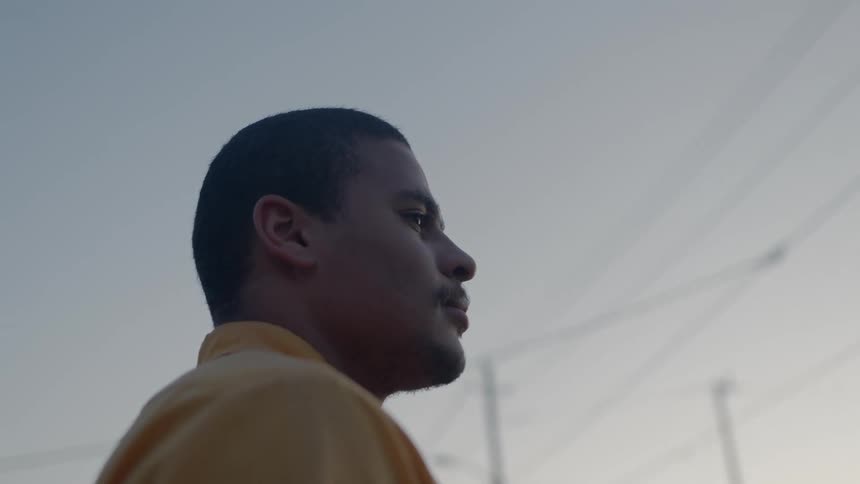 A man standing outside at sunset