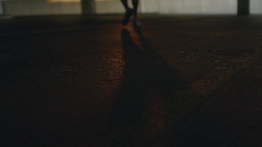 A person walks across a street
