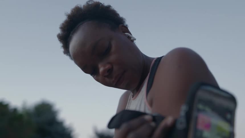 Woman putting phone on arm