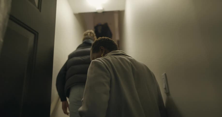 Two people walking into a house