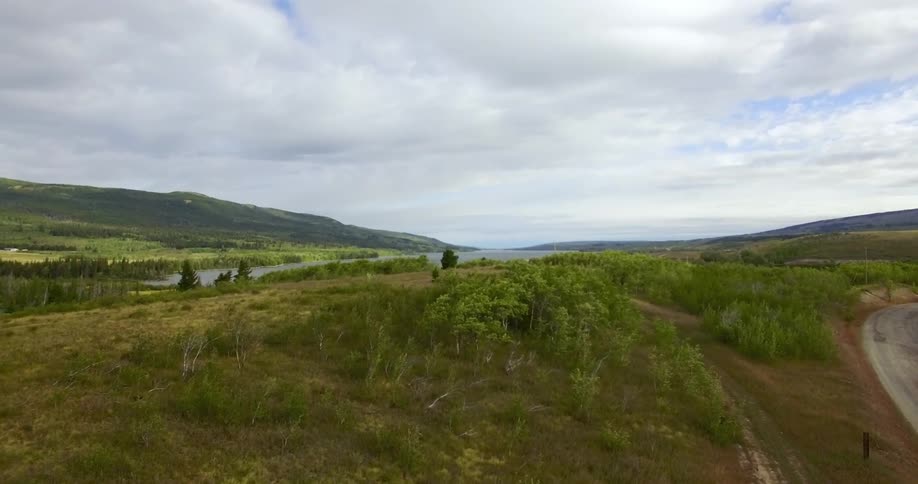 Aerial view moving over a green hill