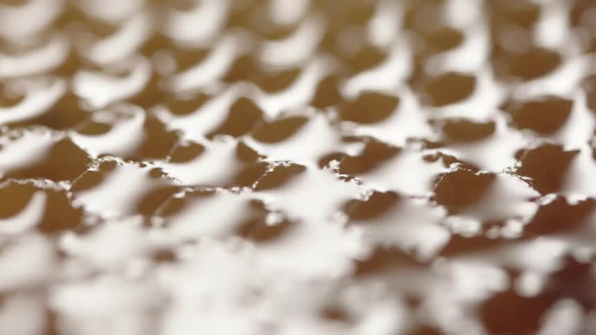 A light turns on and off over honeycomb