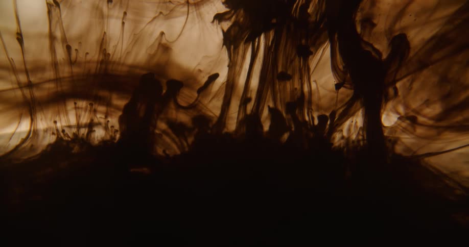 Black dye spreads tendrils through clear ink