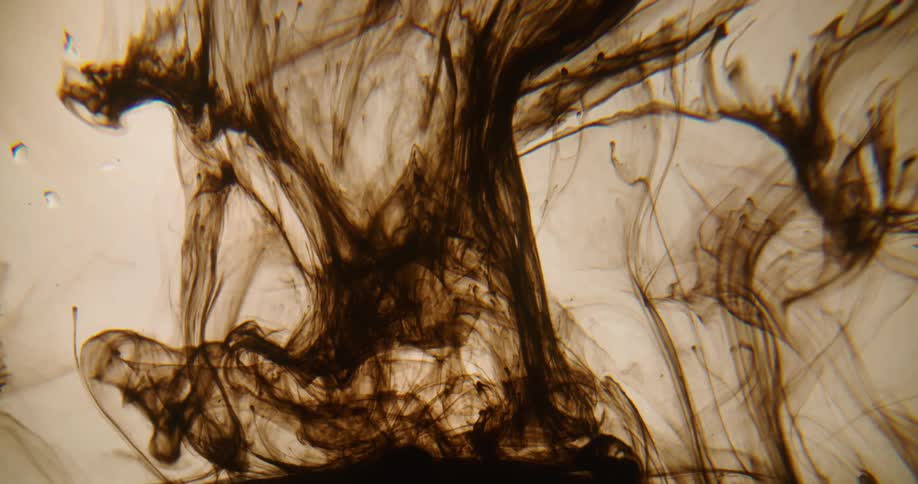 Black dye rises and spreads tendrils through clear fluid