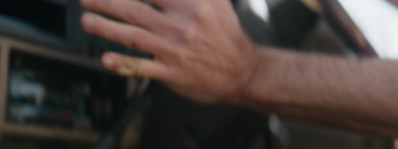 A man shifts gears while driving