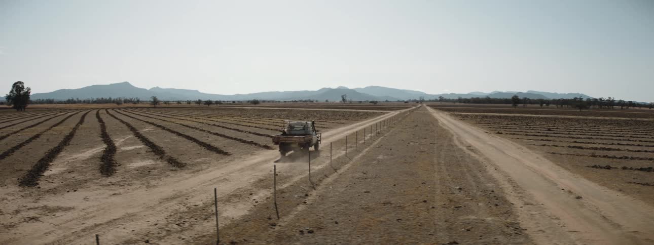 A view of a truck driving on a farm
