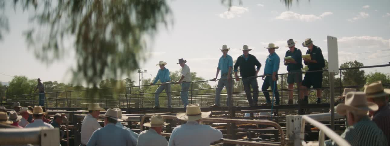 A group of farmers standing around outdoors