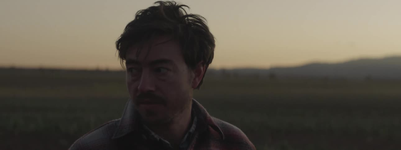 A man searches around the large field